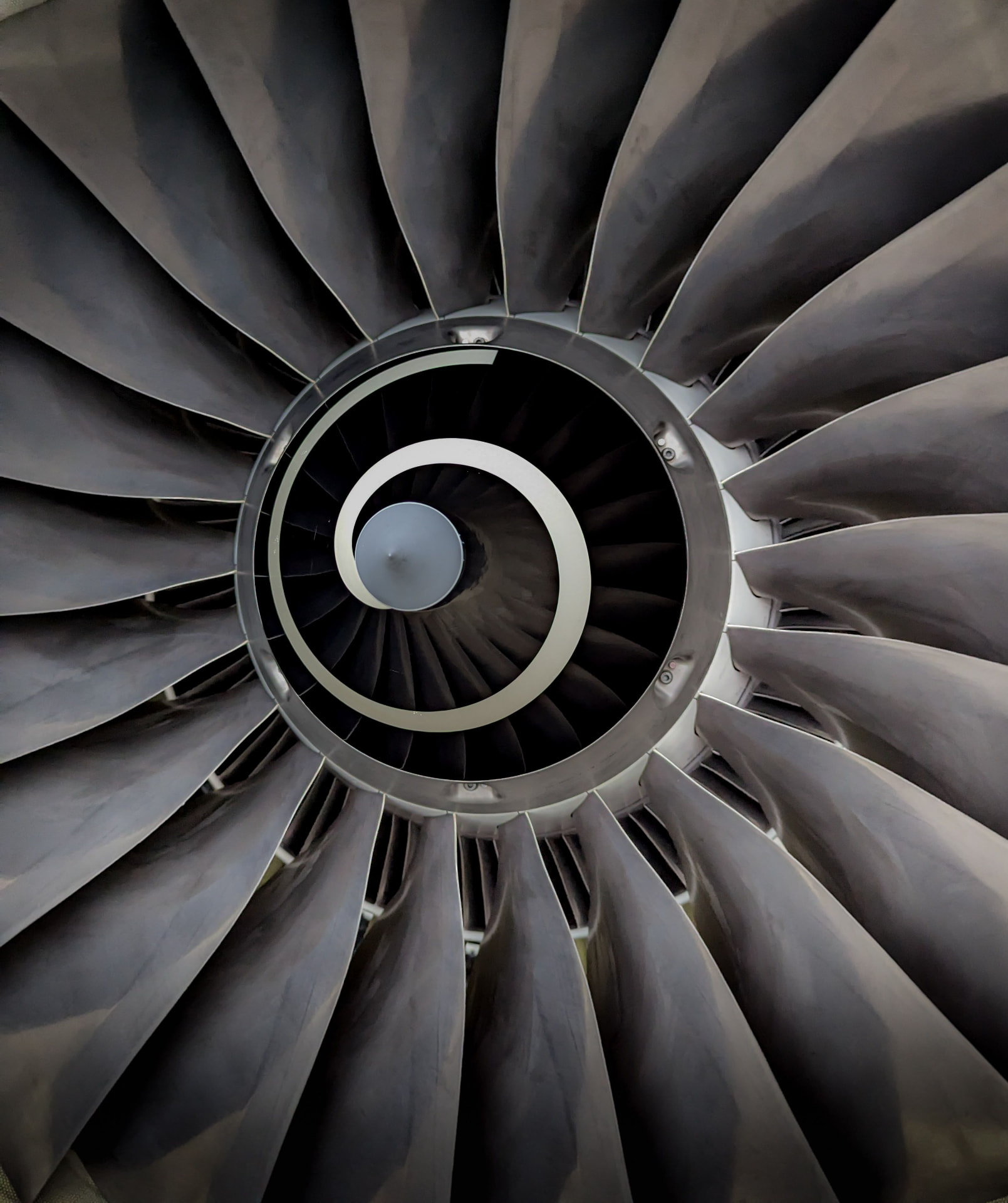 Close-up of a jet engine turbine fan on an aircraft manufacturing line